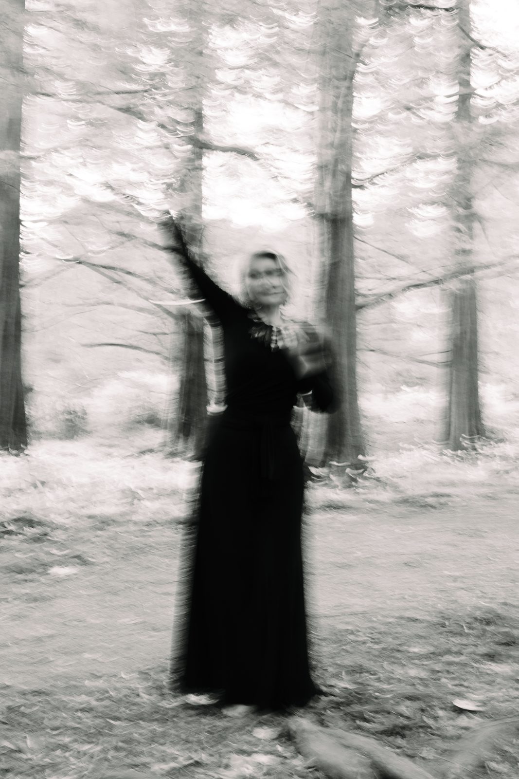 Lara in motion among trees, soft black and white